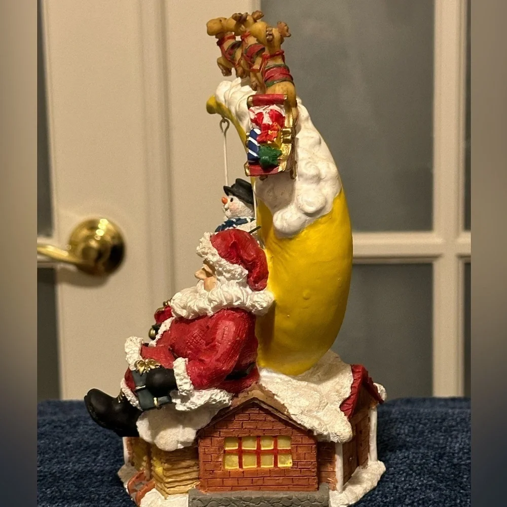 Sleepy Santa rests while a snow buddy swings. Missing bottom